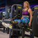 Fitness enthusiast working out on leg curl machine, focusing on strength training.